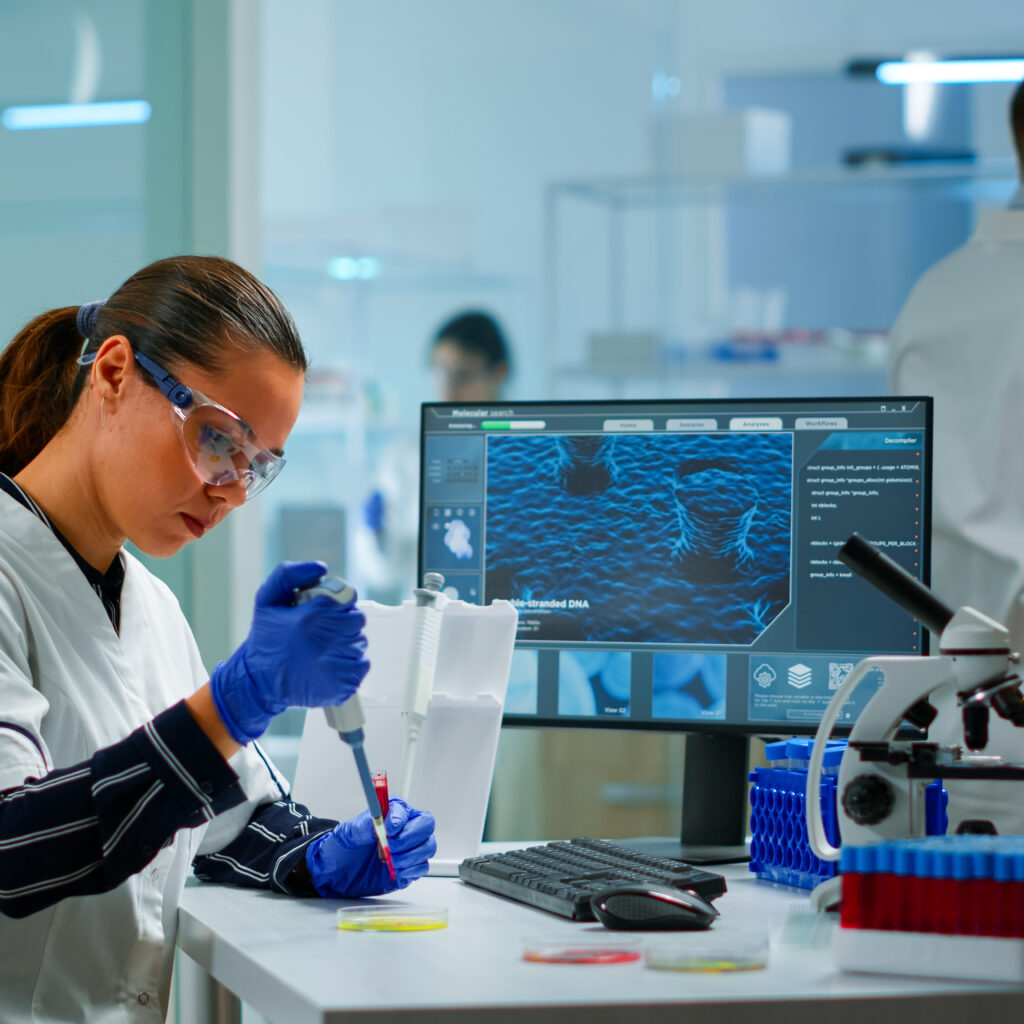 scientist modern equipped medical laboratory examinining drug discovery with micropipette medical stuff examining vaccine evolution using high tech technology researching treatment developmen